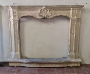 Venetian stone fireplace from the 1700s decorated with a shell and floral elements
